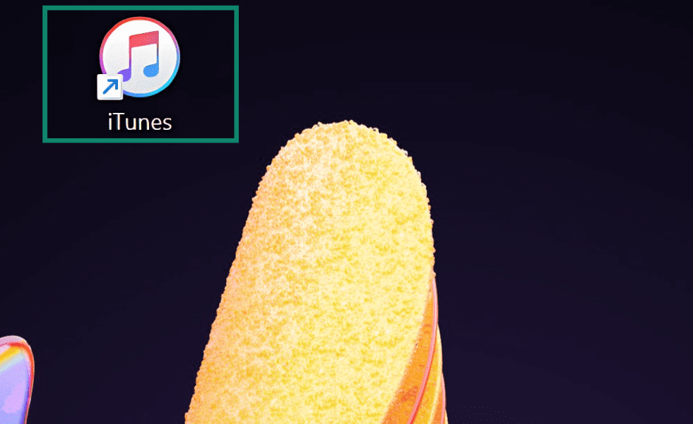 iTunes desktop shortcut icon highlighted on a colorful desktop background.