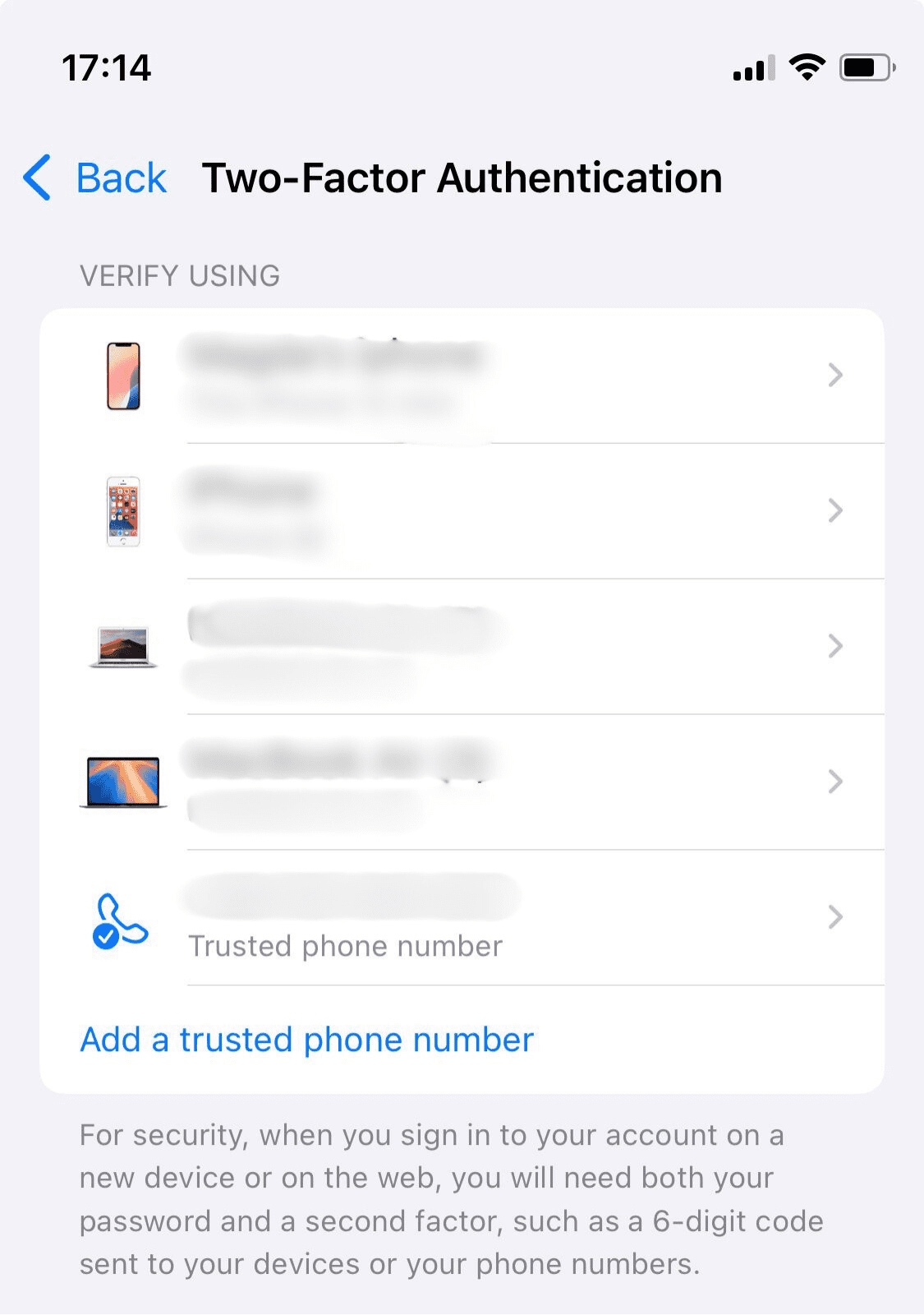 A list of trusted devices on an iPhone with an option to add a trusted phone number.